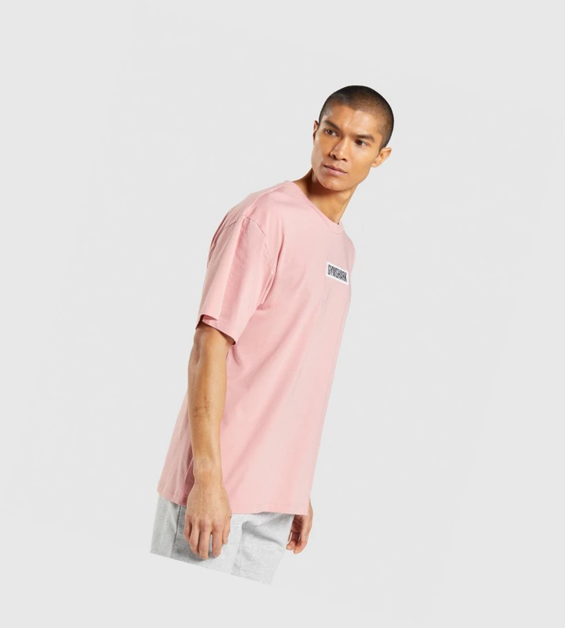 Camiseta Gymshark Central Oversized Hombre Rosas | IDXKVUG-61